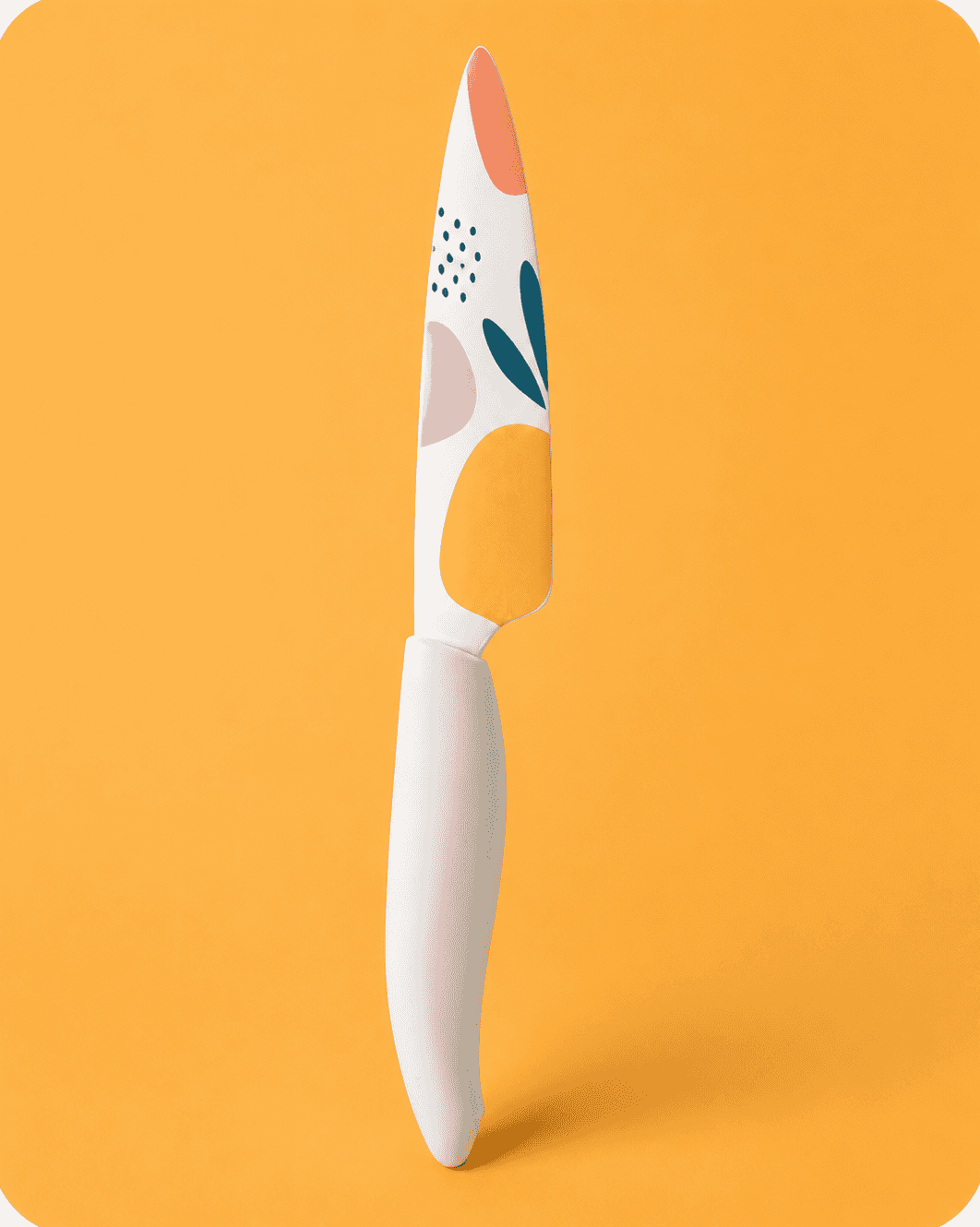 Kitchen knife printed with a modern abstract pattern on a yellow background.